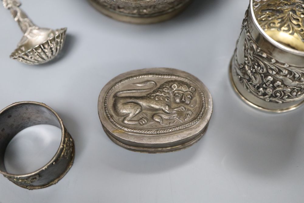 An Edwardian silver christening mug, a Victorian silver foliate sifter spoon, Indian? bowl, Chinese napkin ring & a snuff box.